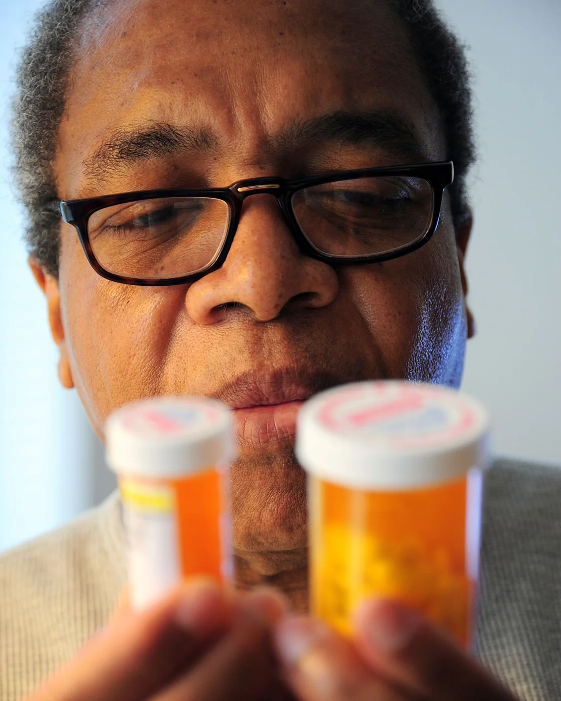 A man comparing two supplement labels up close