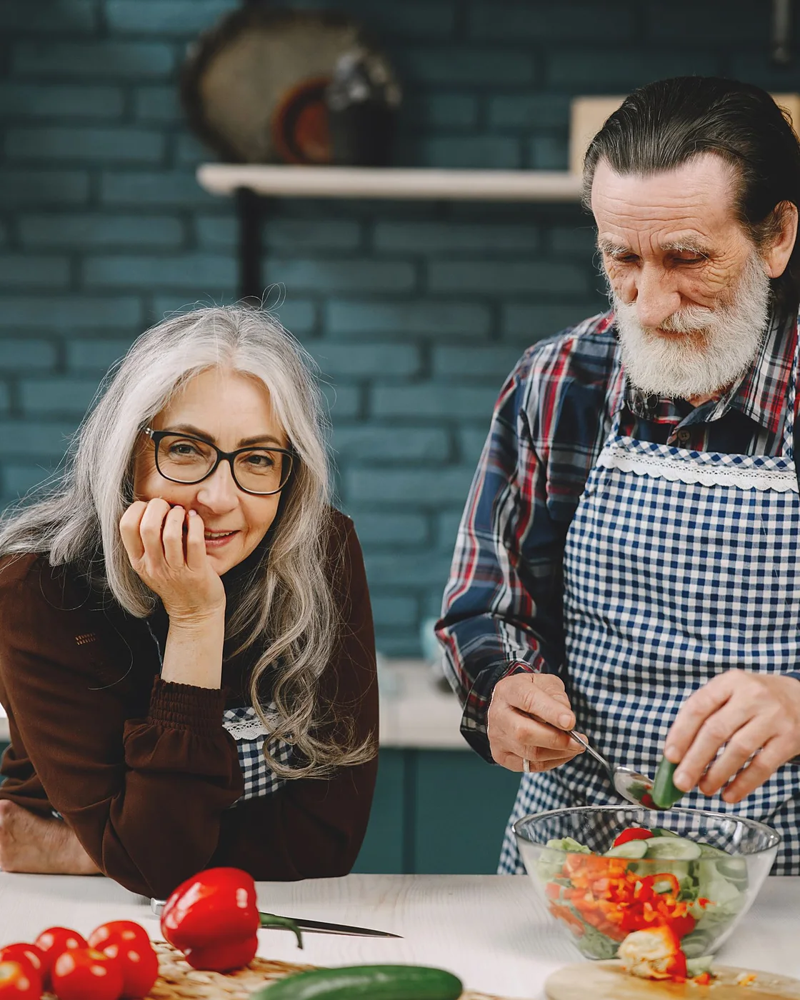 A couple preparing a fresh salad together at home