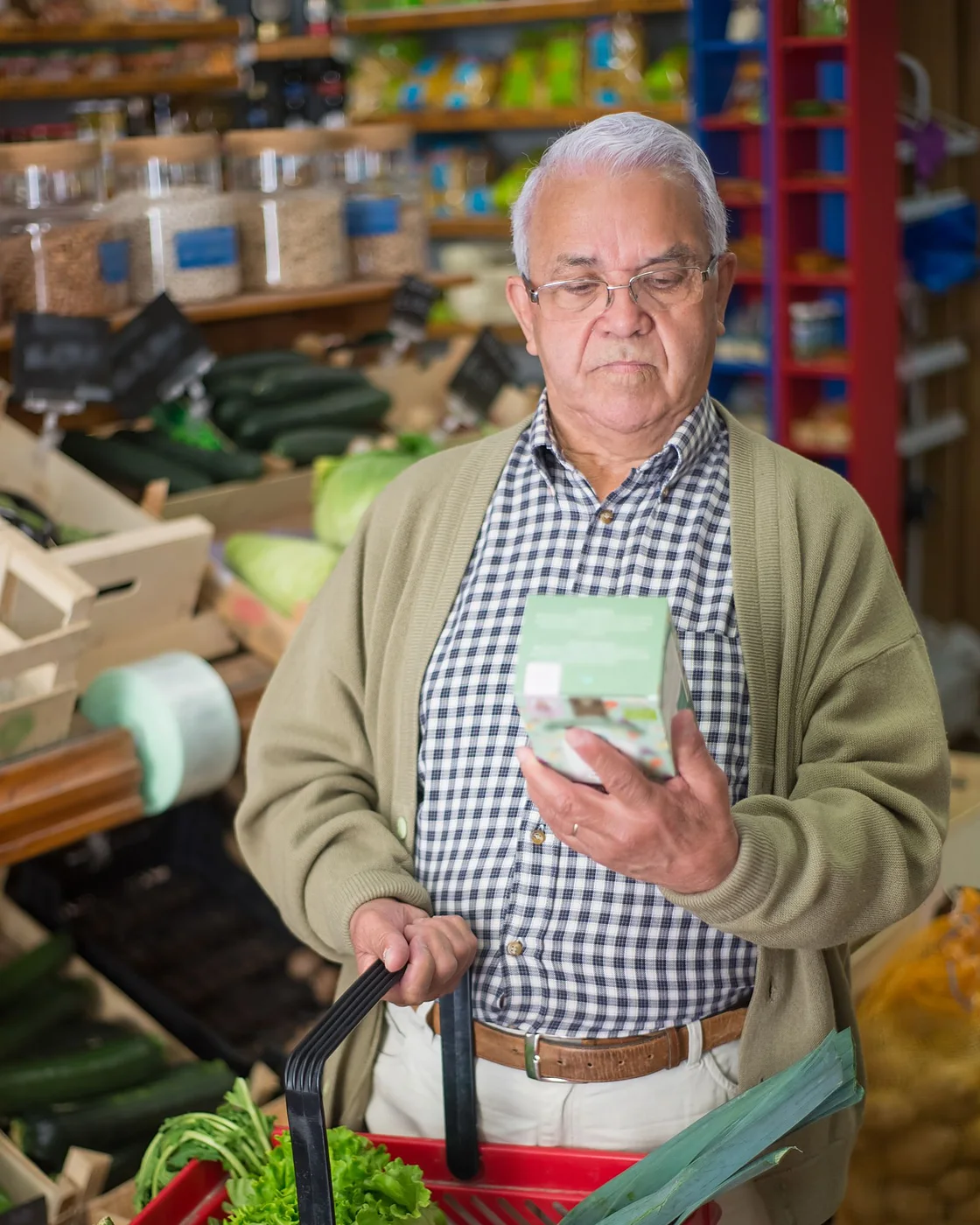 A man comparing supplements while shopping