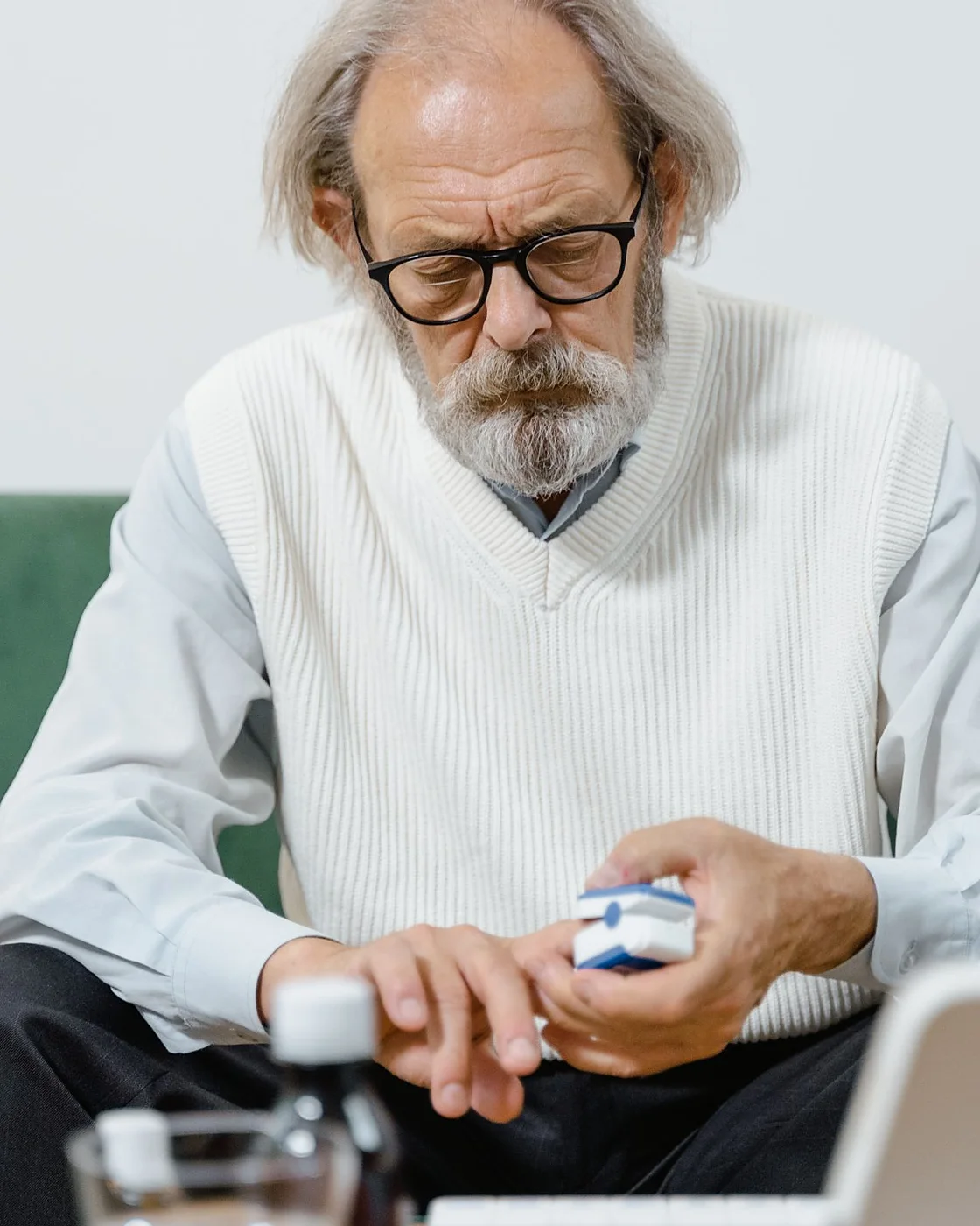 A man checking a supplement bottle at home