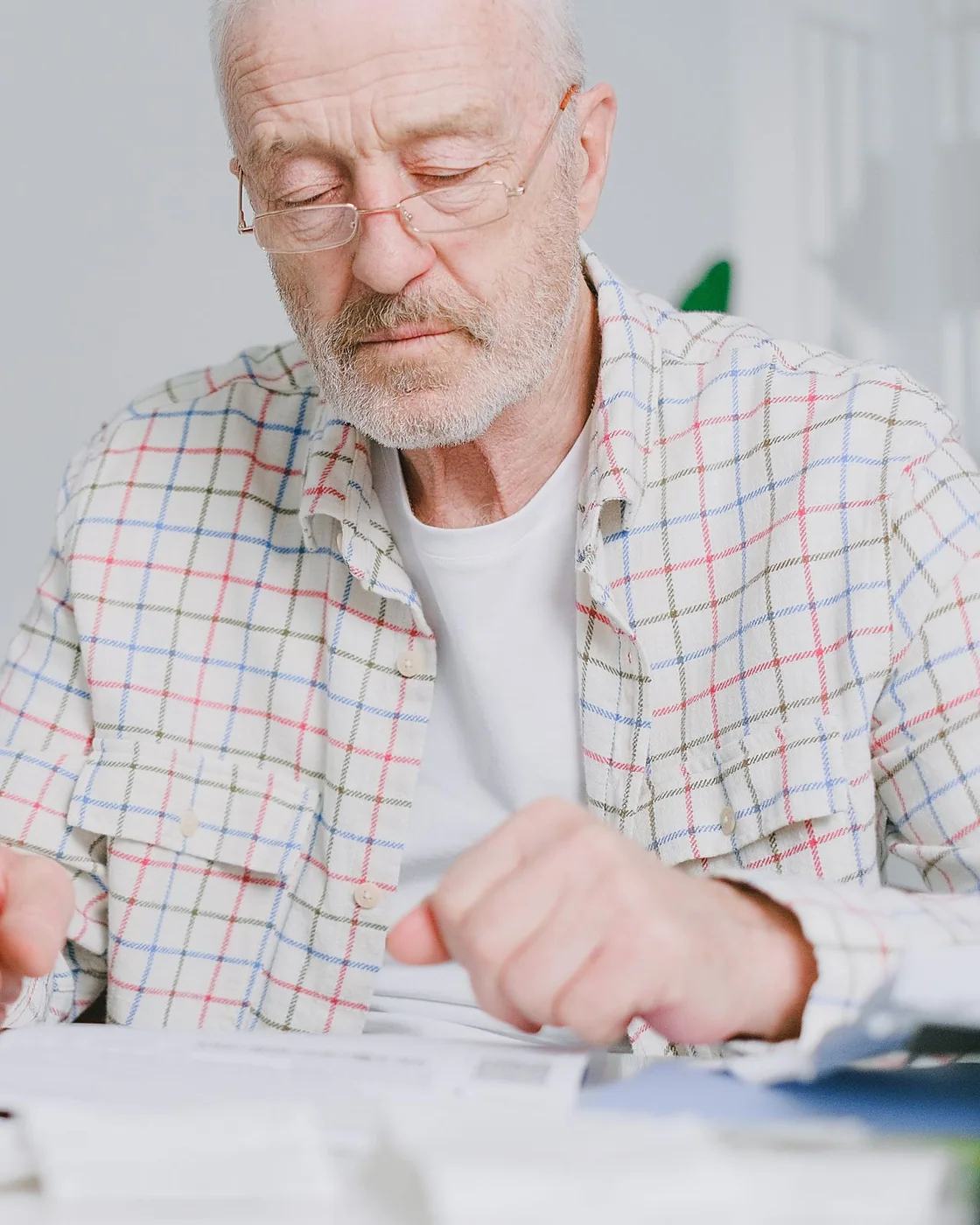 A man reading the small print on his paperwork